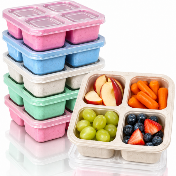 Six 4 compartment bento snack boxes with clear lids, one filled with fruit and carrots