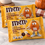 Two bags of M&M's Pumpkin Pie candy on a marble counter
