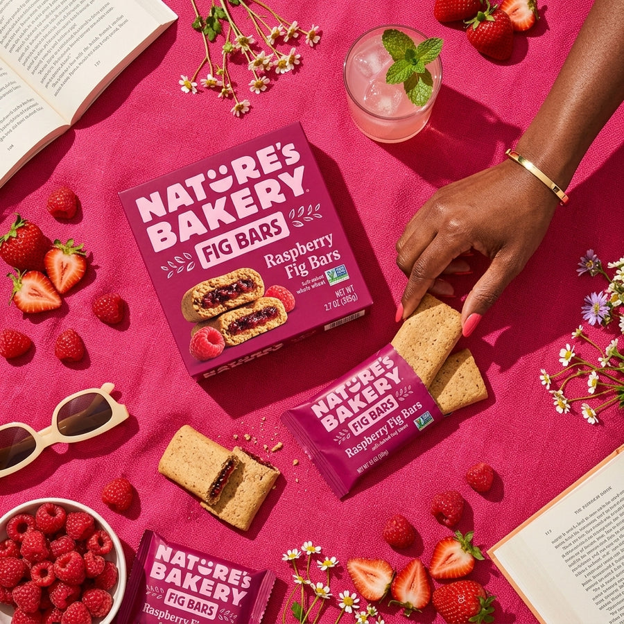 Nature's Bakery raspberry fig bars styled with raspberries and strawberries